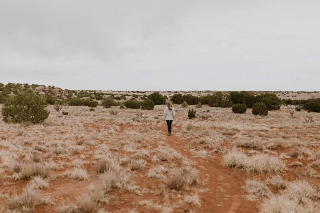 Girl Walking on Red Dirt in the Desert Landscape in Santa Fe New Mexico