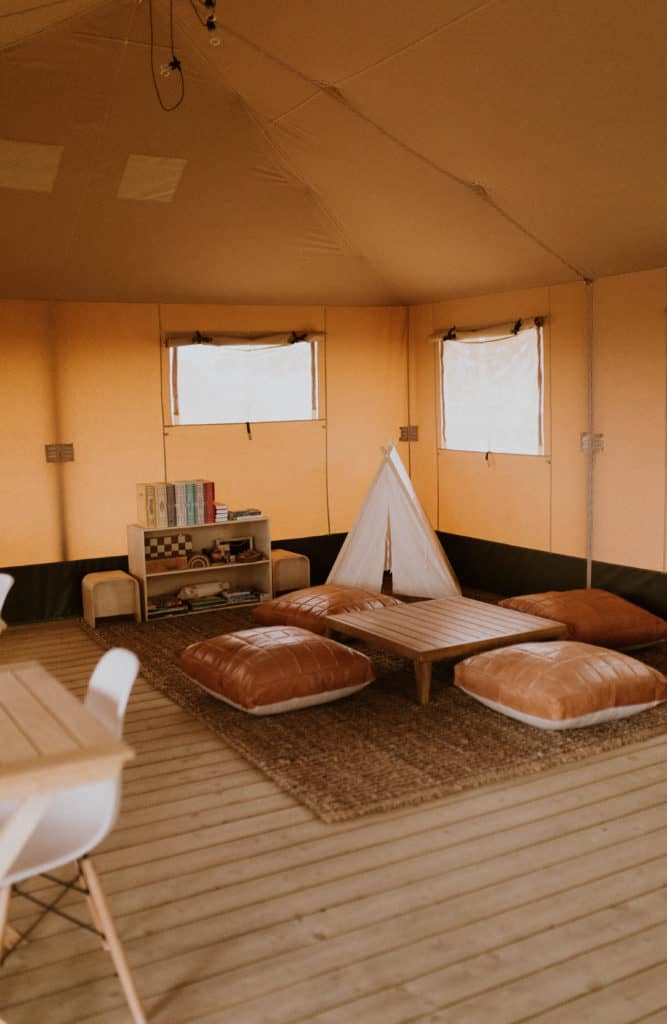 Inside a Canvas Safari Tent with Southwestern Decor and Leather Pillows and Small Children's Teepee