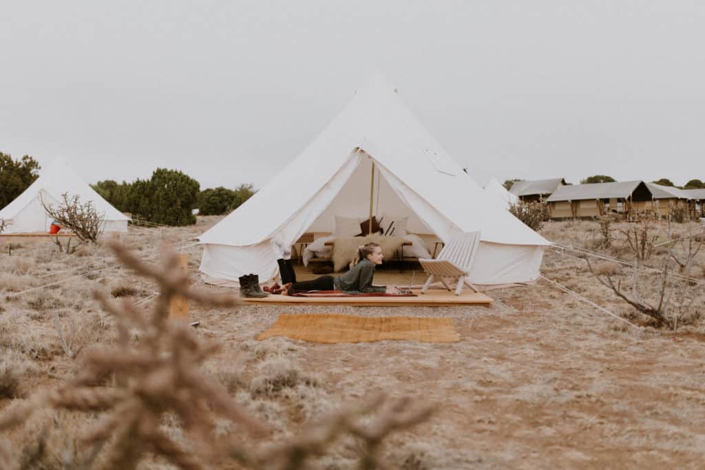 Digital Nomad Girl on Laptop by Glamping Tent in the Desert of New Mexico