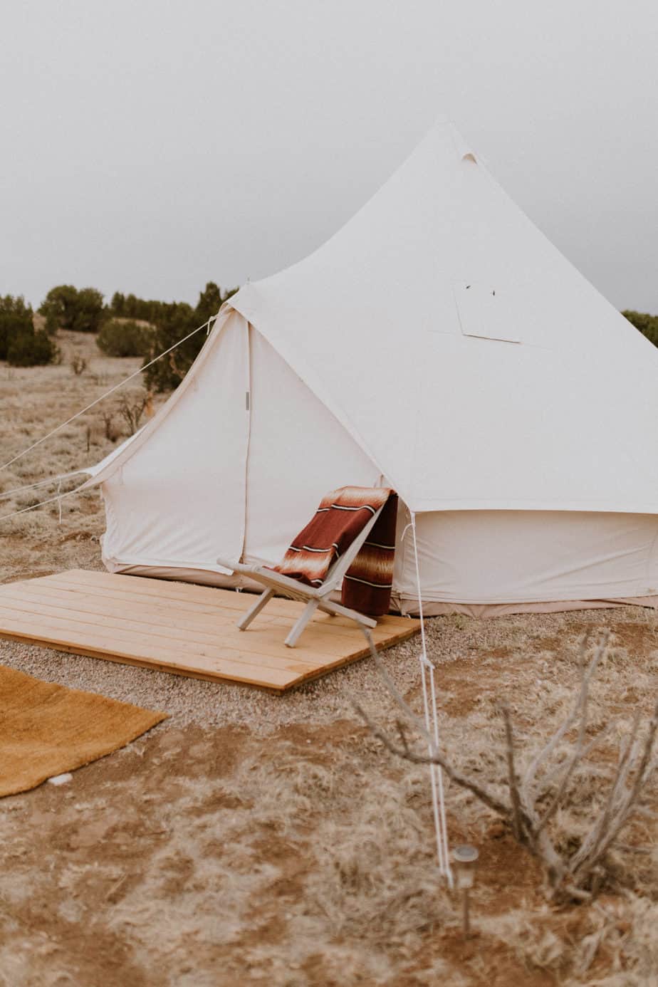 White Canvas Safari Style Tent with Pendleton Soutwest Style Blanket at Glamping Retreat in New Mexico